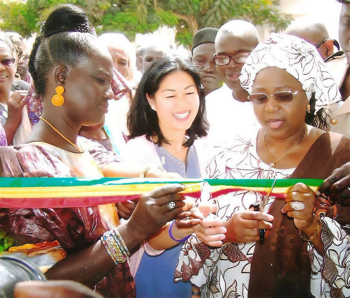 Dr. Awa Marie Coll-Seck, Bryn Sakagawa, and a Senegalese health-sector colleague cut a ribbon to open a health facility in Dakar.