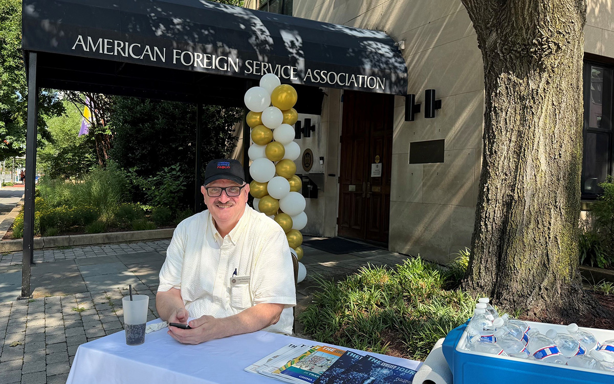 AFSA President John “Dink” Dinkelman sits at a table outside AFSA headquarters in Washington, D.C.