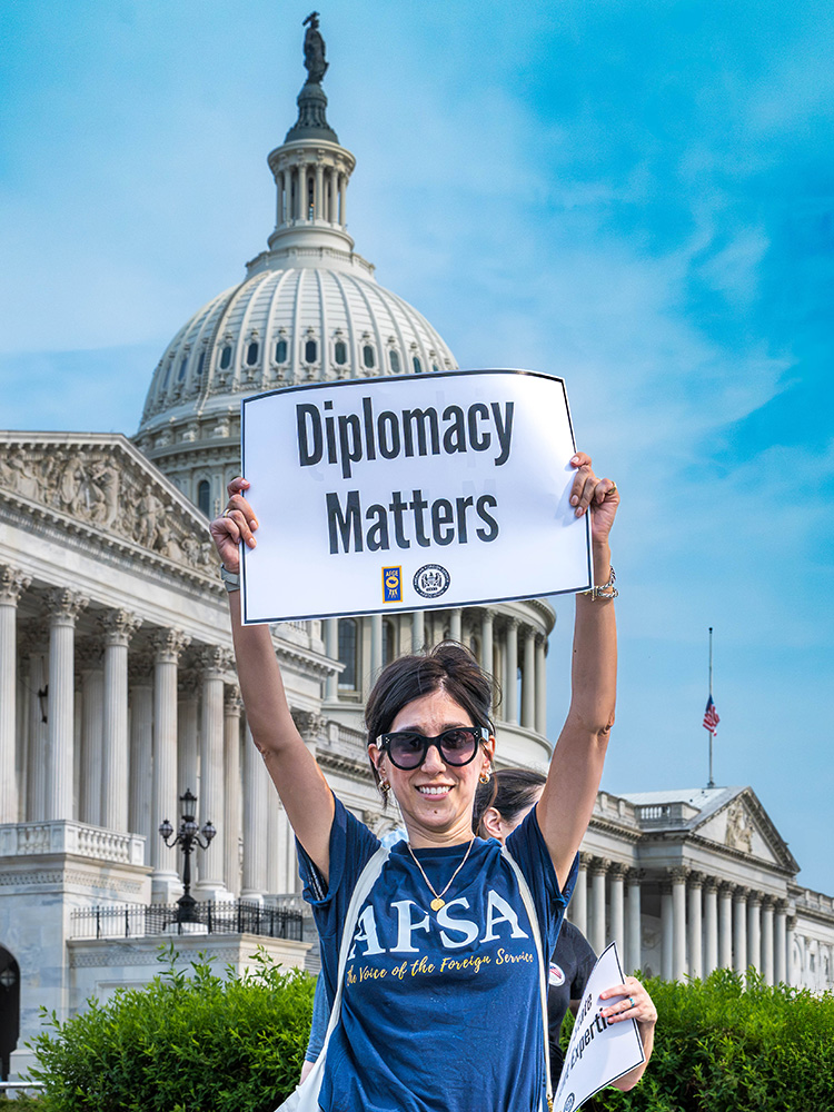 AFSA supporter holds a ‘Diplomacy Matters’ sign in front of the U.S. Capitol.